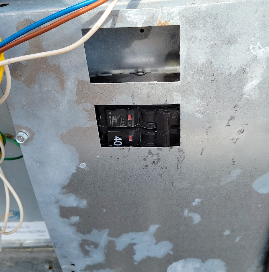 Picture of poor workmansip of a breaker/disconnect in a package unit.